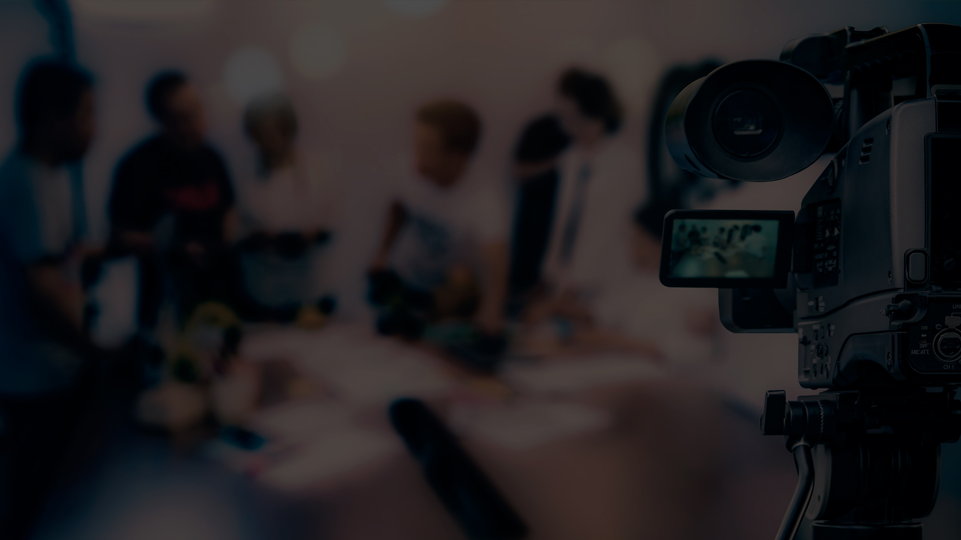 A group of people on a video production set and a filming camera, highlighting the importance of video content in the modern business world.
