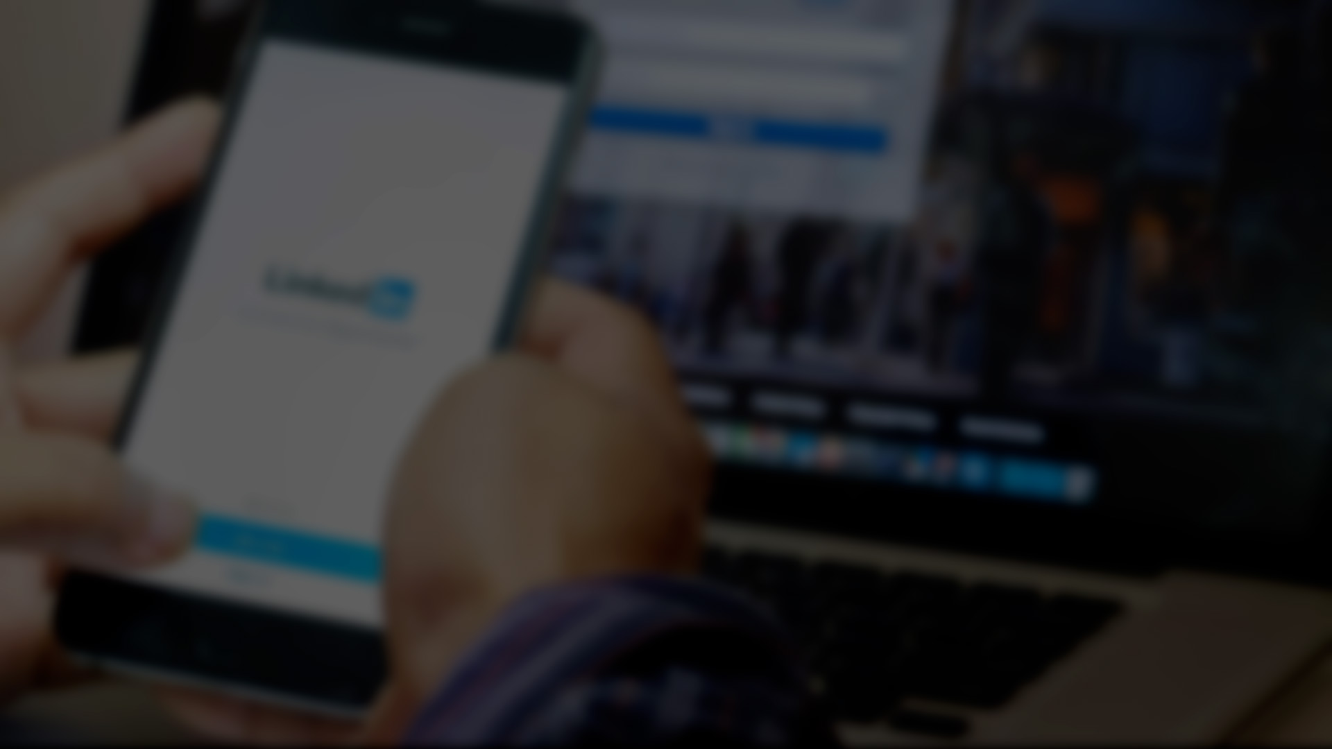 Blurred image of a laptop screen displaying the LinkedIn login page, representing professional networking and digital marketing.